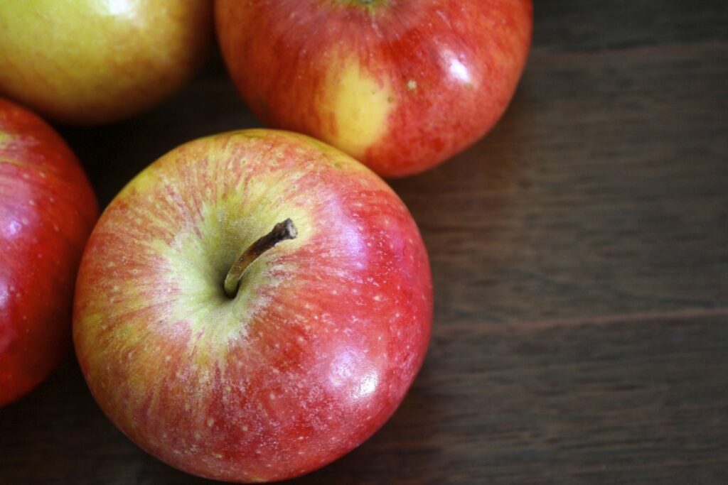 Closeup on red apples on wooden