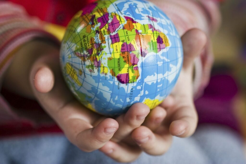 Free hand holding world globe